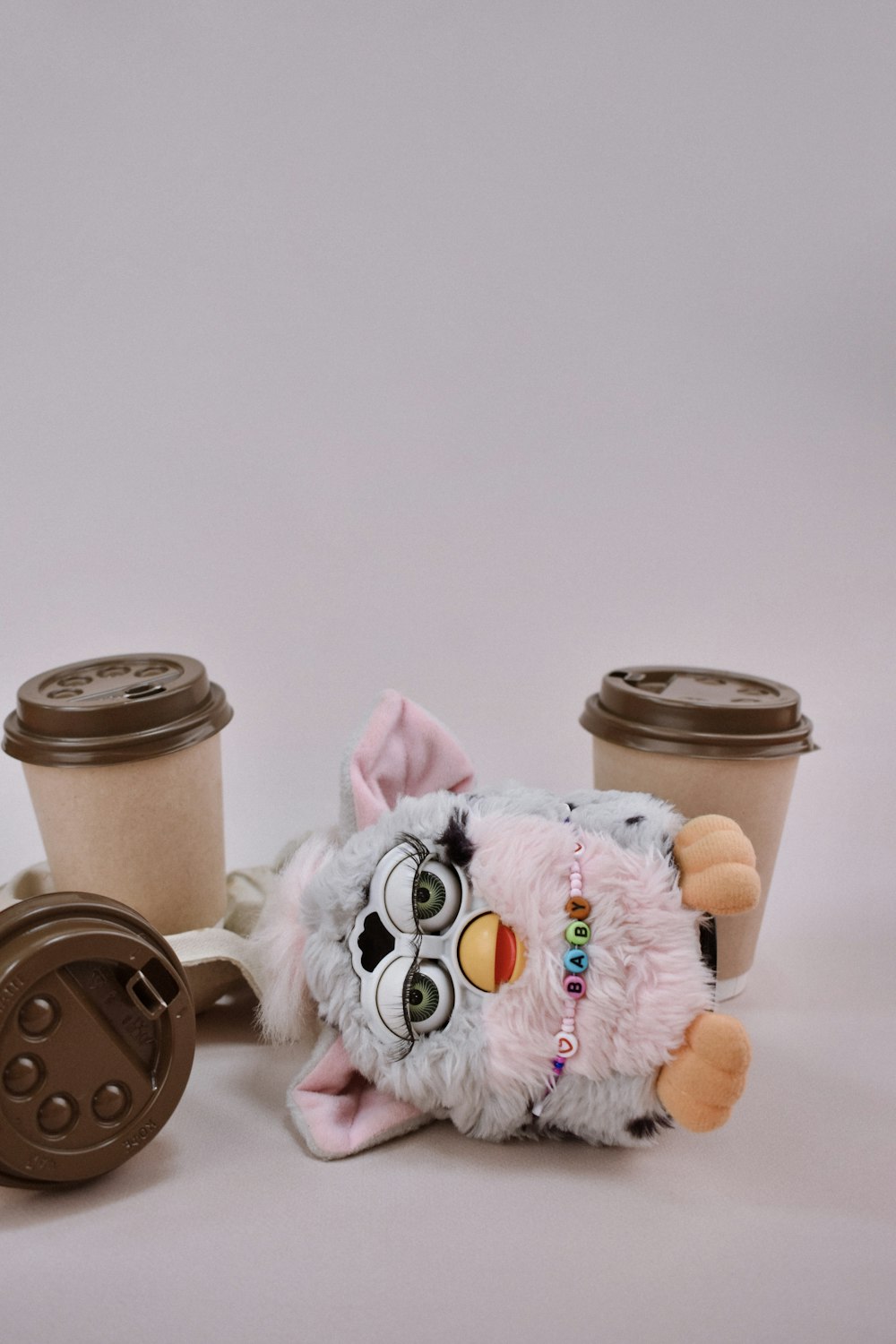 a stuffed animal next to a cup of coffee