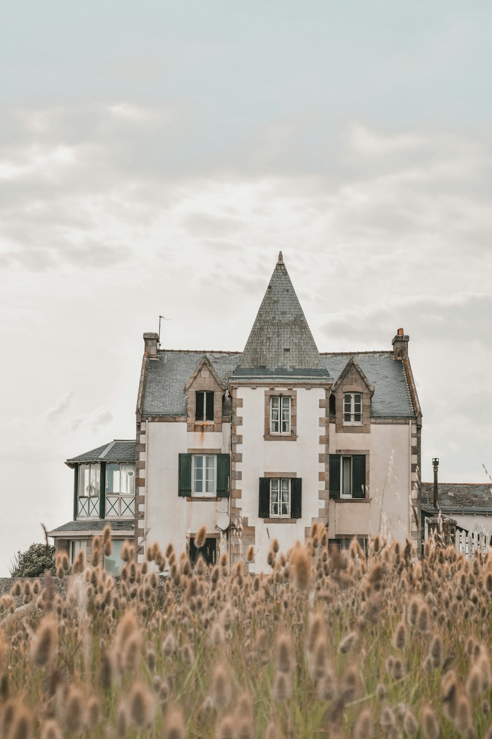 a large house sitting in the middle of a field