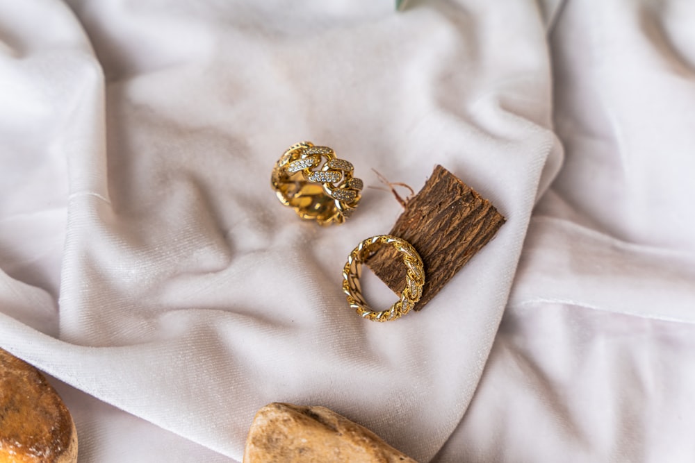 a couple of rings sitting on top of a white cloth