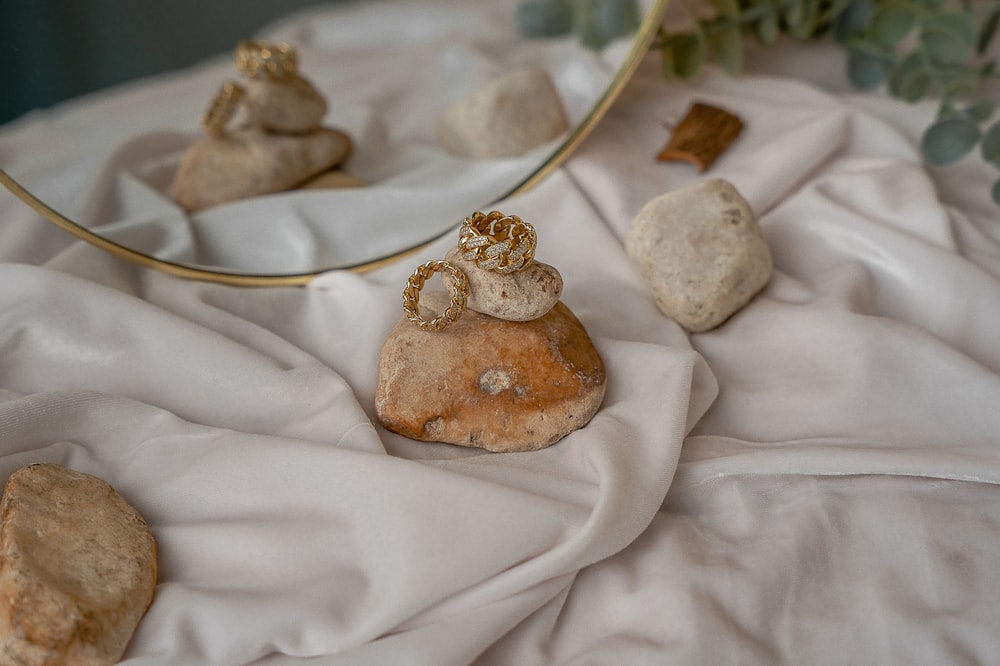 a mirror and some rocks on a table