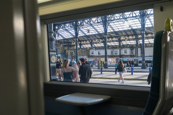 A panoramic view of a newly constructed railway station platform bustling with commuters.