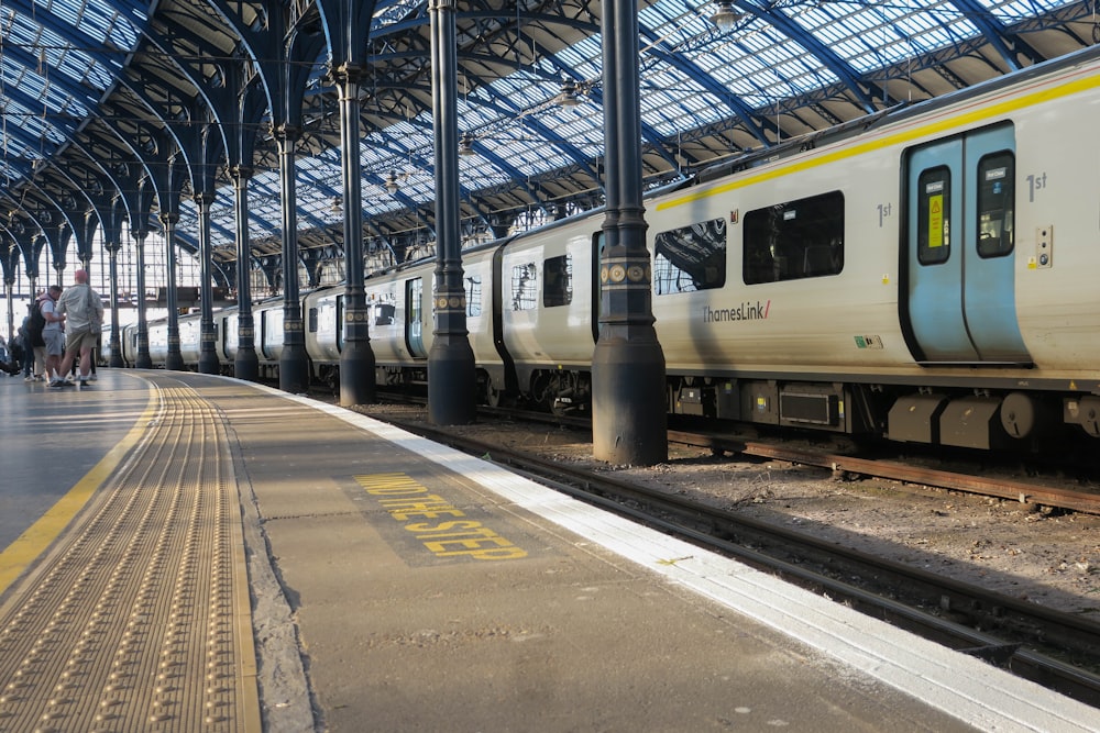 a train pulling into a train station next to a platform