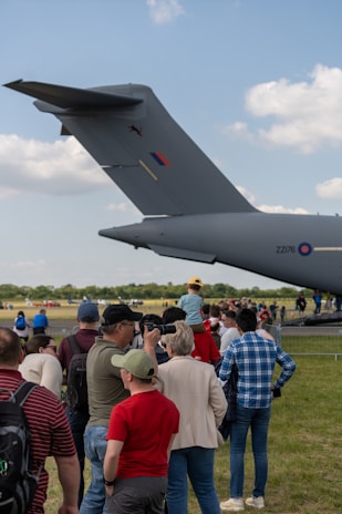 A group of members gathered around one of the aircraft.