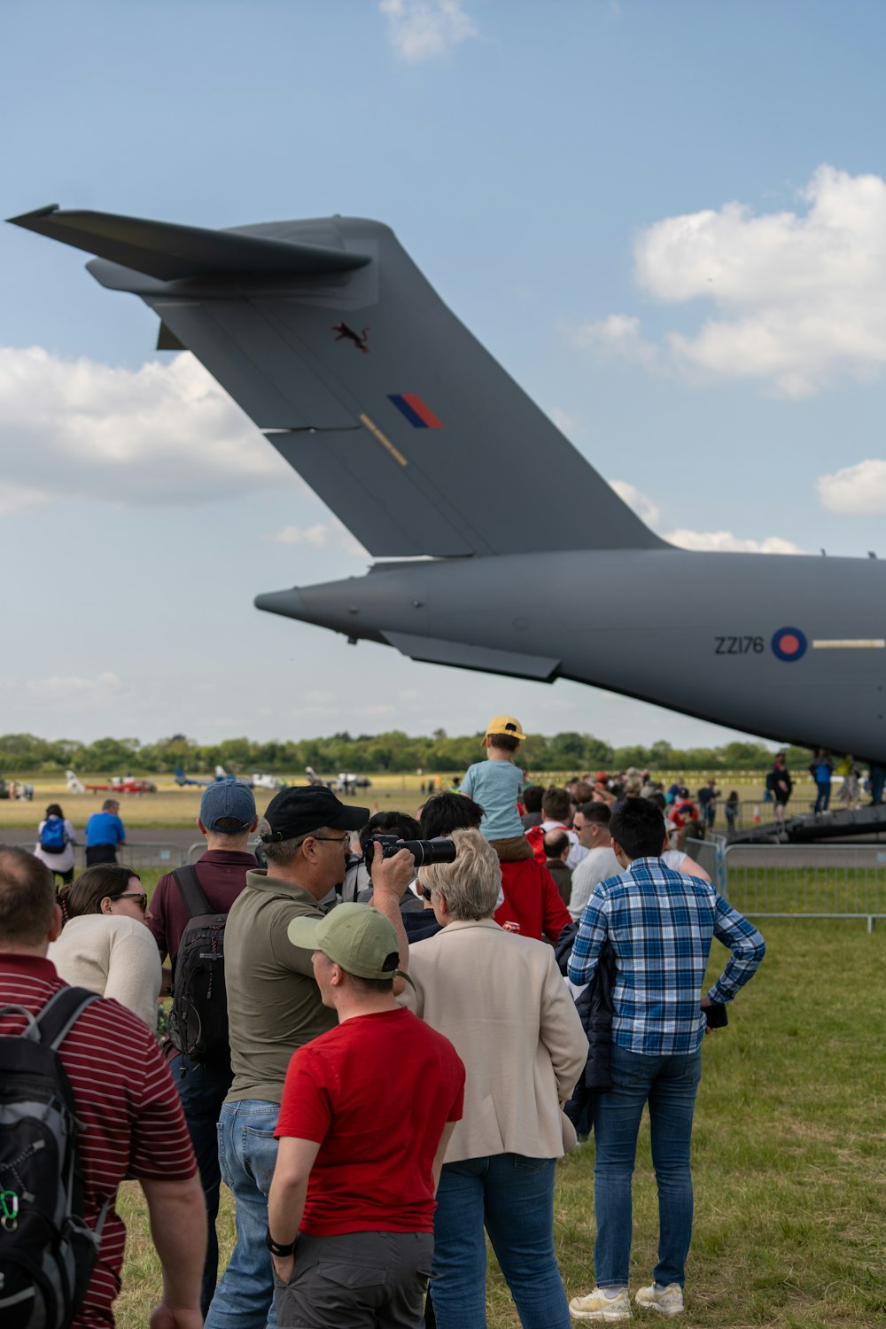 a group of people standing in front of a plane