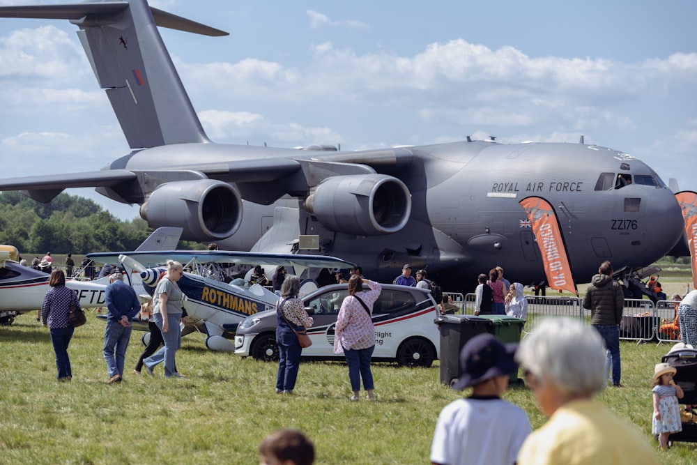 a crowd of people standing around a large airplane