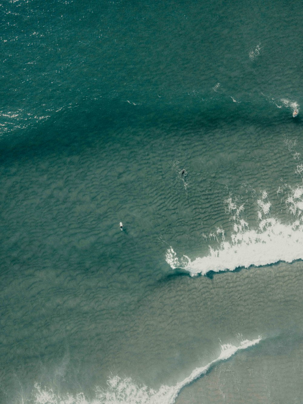 a person riding a surfboard on a wave in the ocean