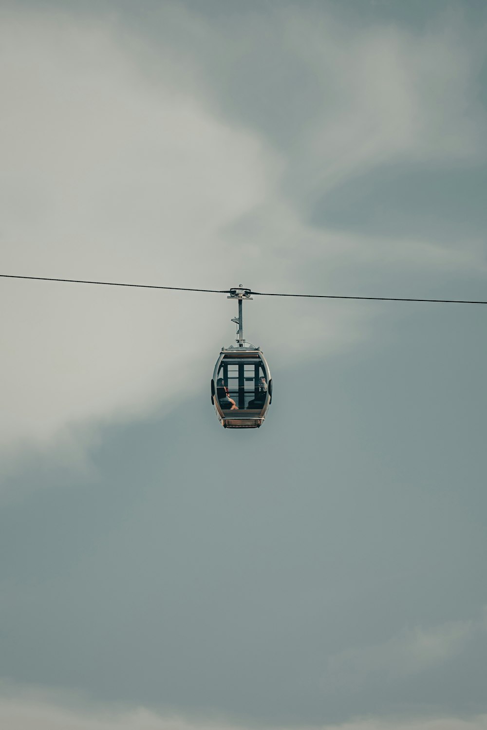 a cable car with a person sitting on it