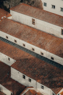 an aerial view of a building with red tile roofs
