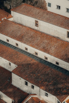 an aerial view of a building with red tile roofs