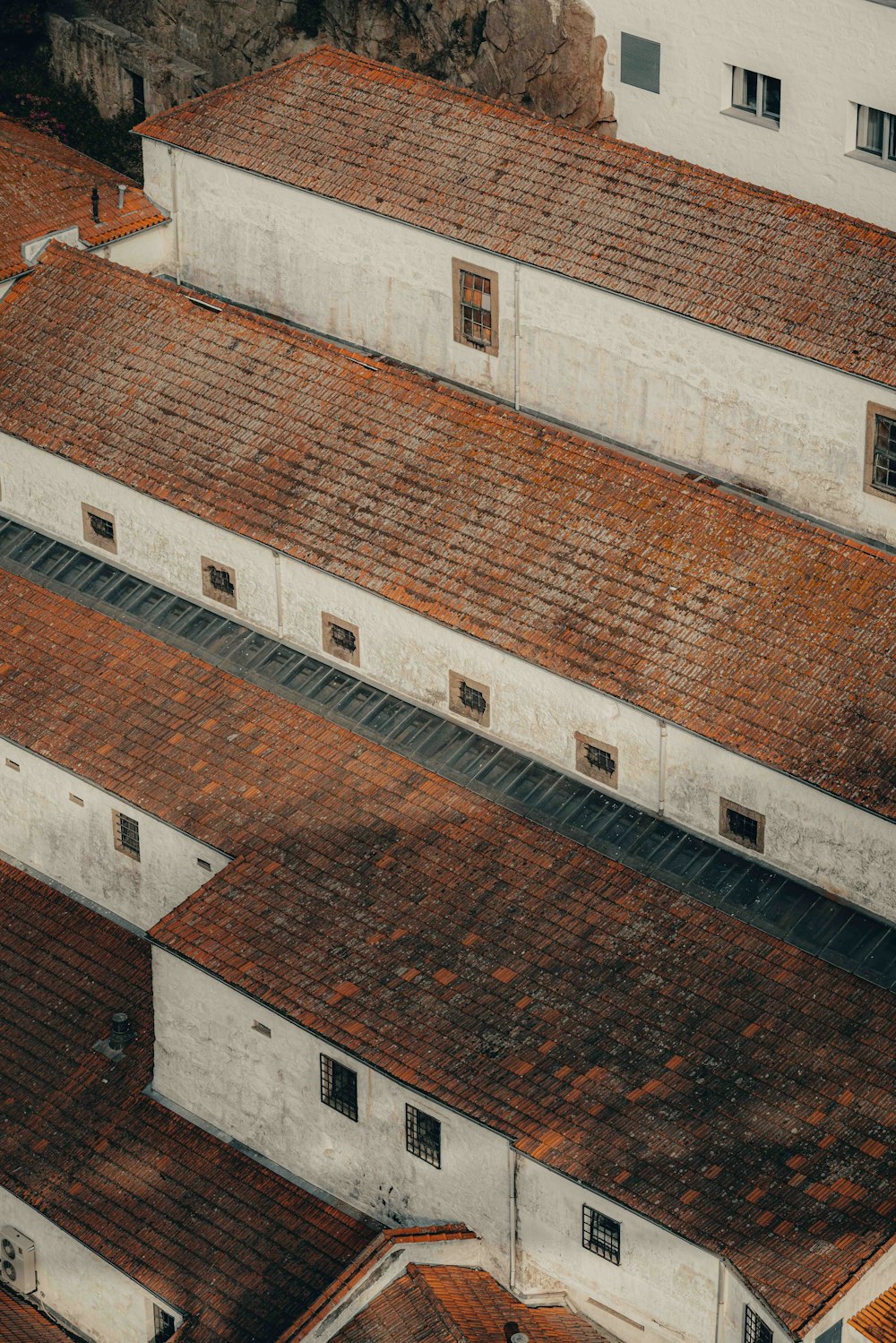 an aerial view of a building with red tile roofs