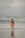 a man standing on a beach next to the ocean
