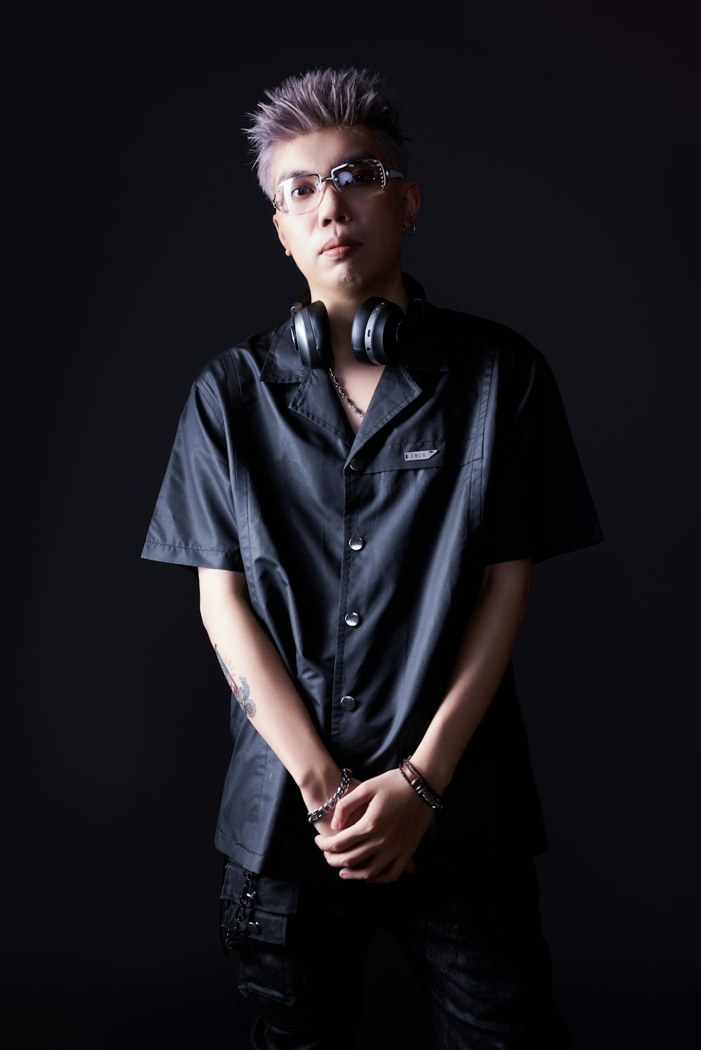 a man wearing headphones and a black shirt