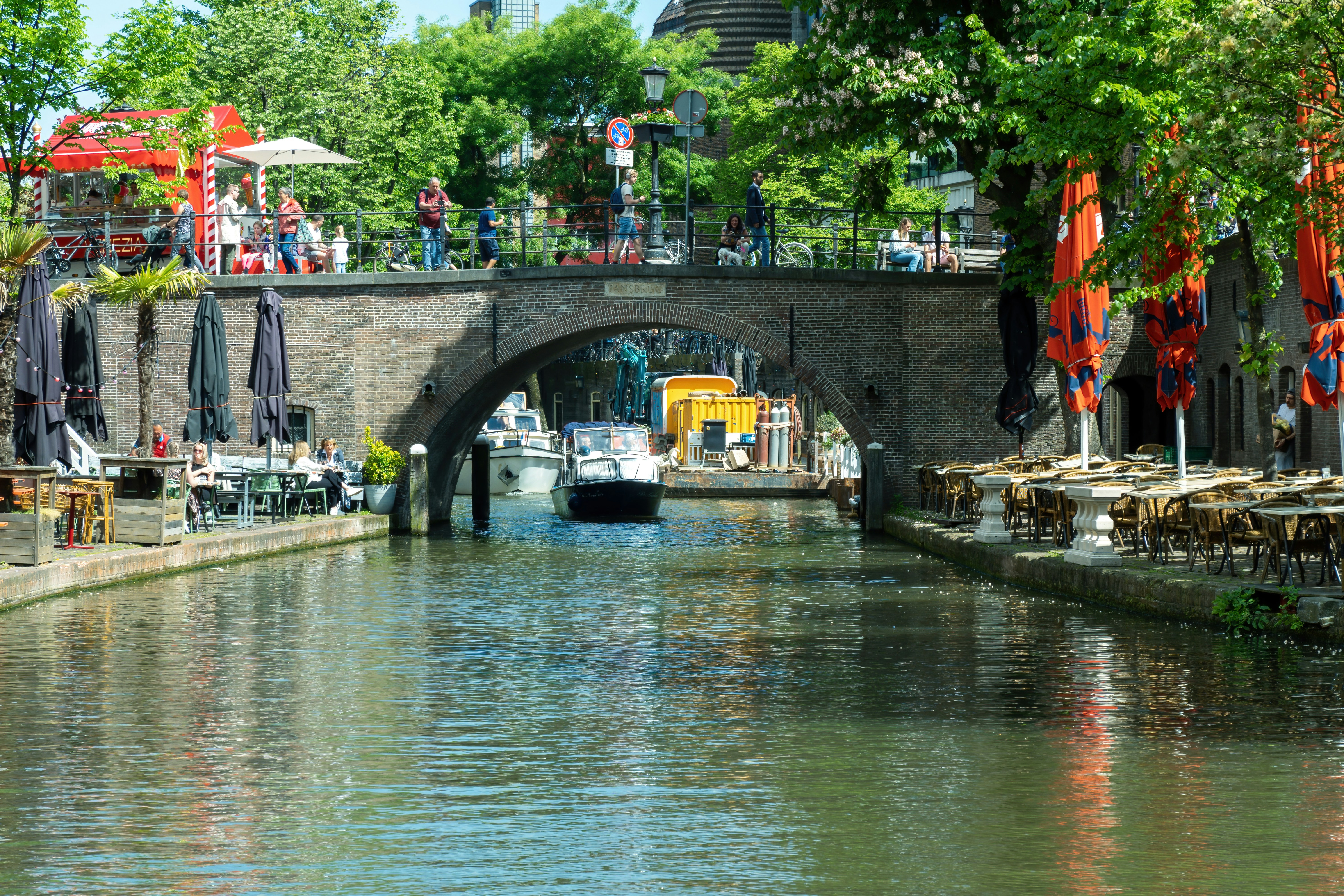 Boat traveling under historic bridge