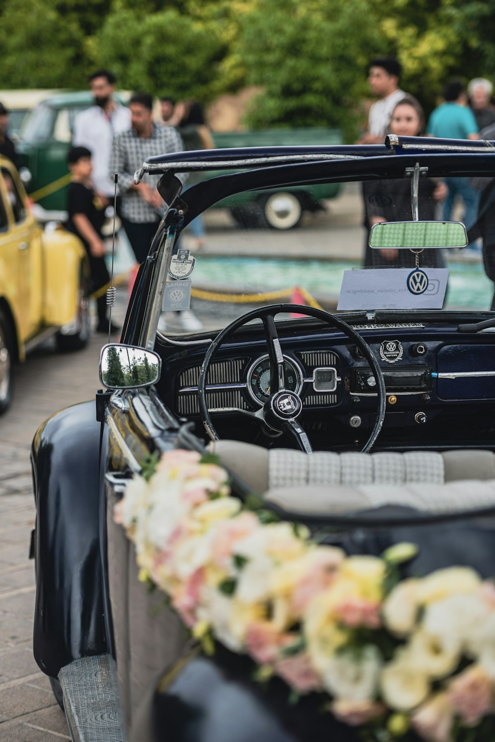 a car with a wreath of flowers on the dashboard