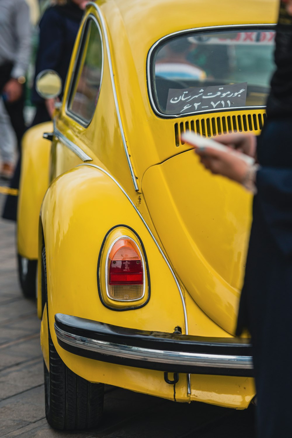 a close up of the tail end of a yellow car