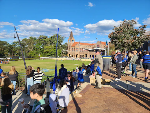A vibrant local sports tournament with teams competing on a sunny day
