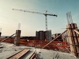 Construction site with cranes and building materials stacked neatly.