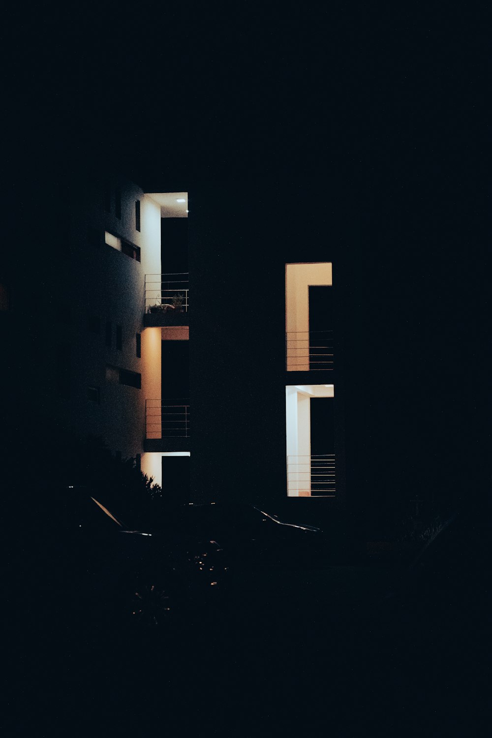 a black and white photo of a building at night