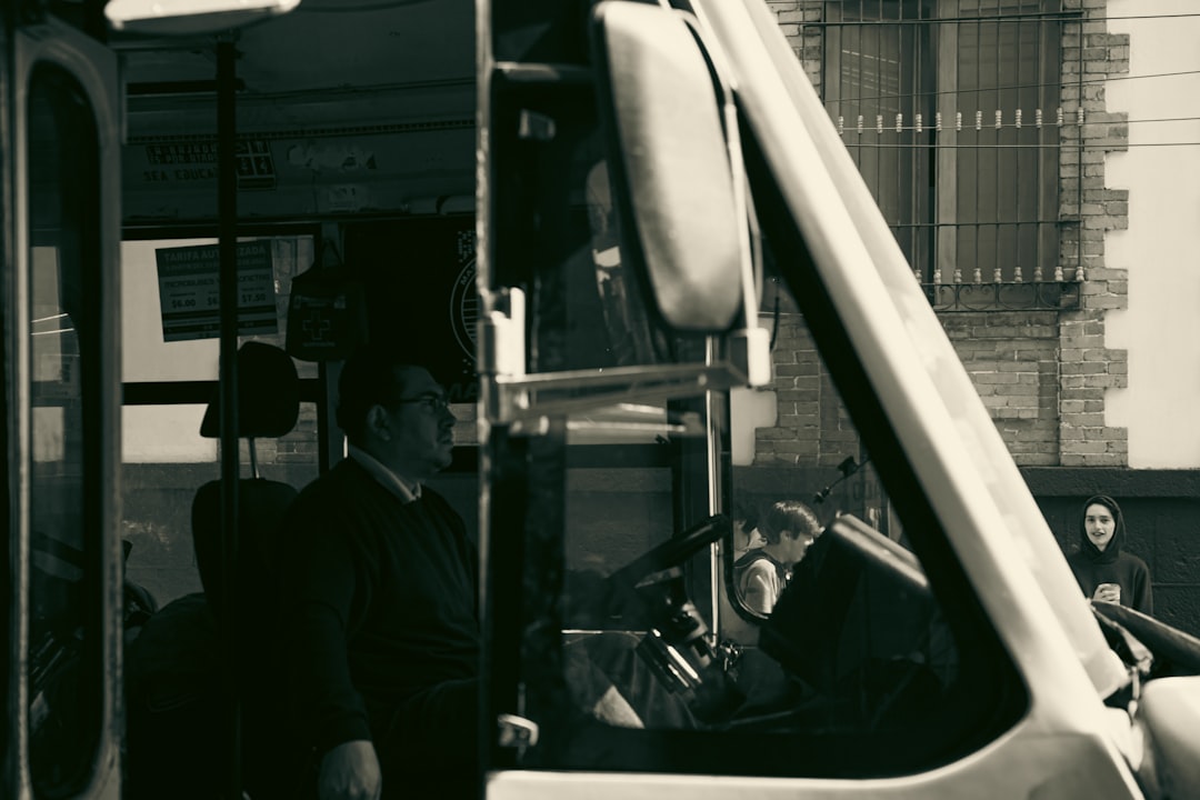 a black and white photo of a bus driver,
