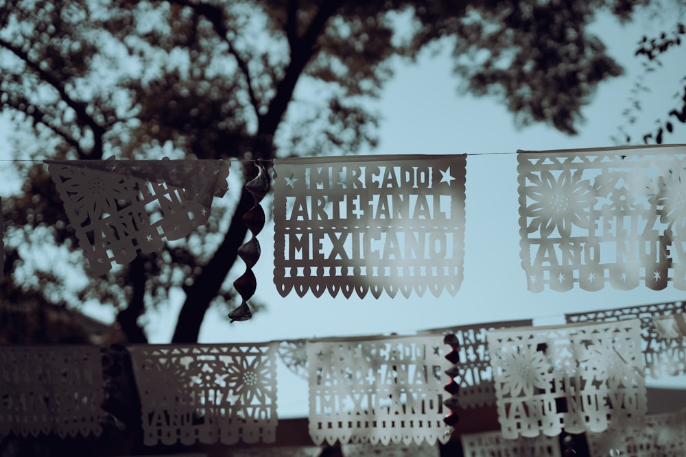 a string of cut paper hanging from a tree