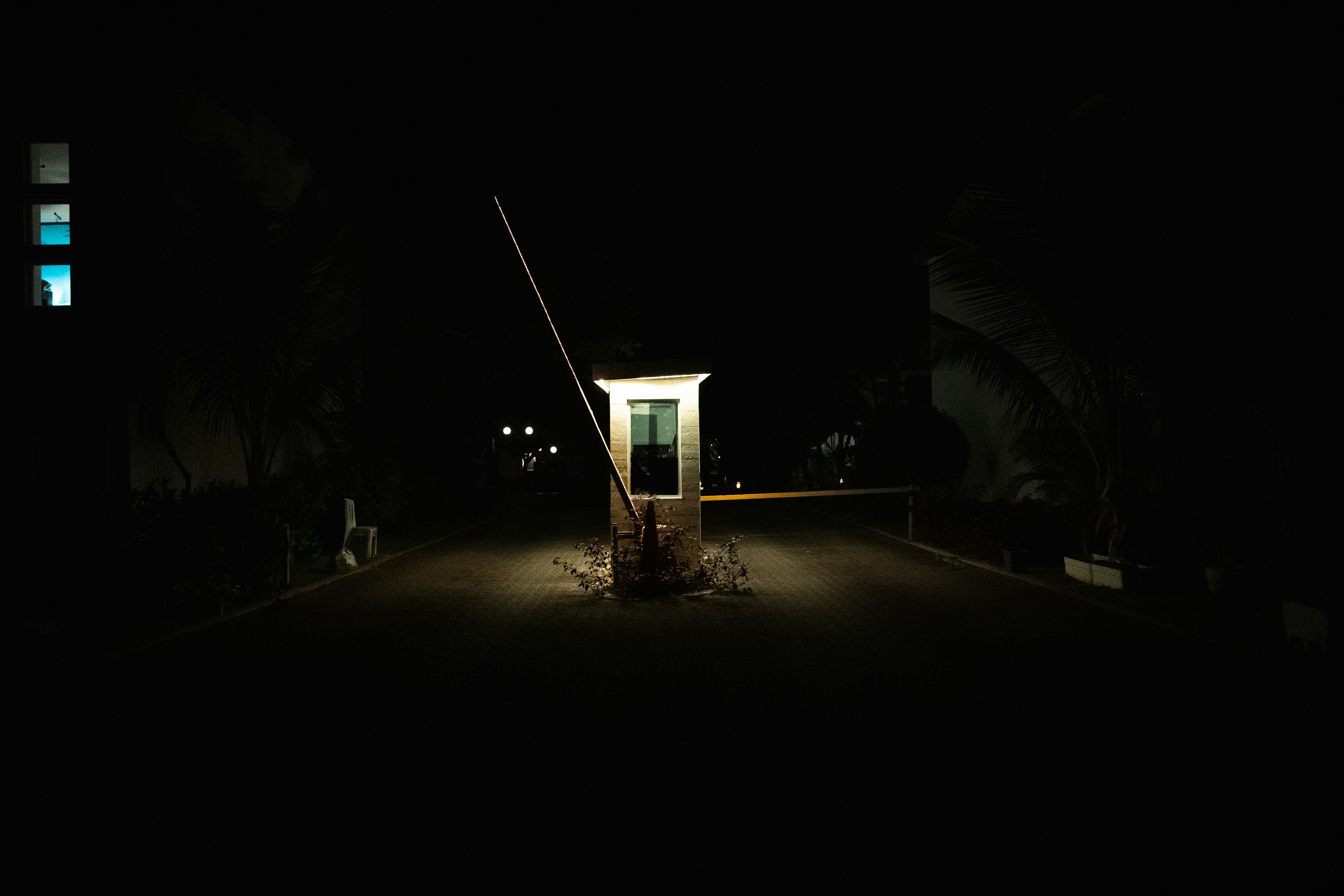a dark street at night with a light on