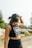 a woman with headphones on walking down a road