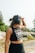 a woman with headphones on walking down a road