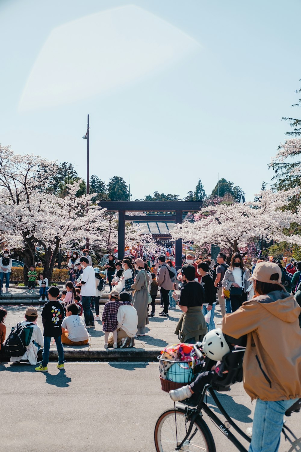 a group of people standing around in a park