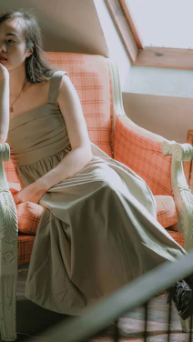 Portrait of Cynthia Chadwick in a calm, elegant setting with soft gold and deep forest green accents.