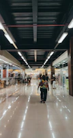 A spotless shopping mall corridor shining under bright lights after a thorough cleaning.