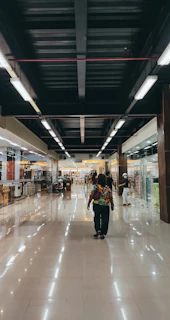 A spotless shopping mall corridor shining under bright lights after a thorough cleaning.