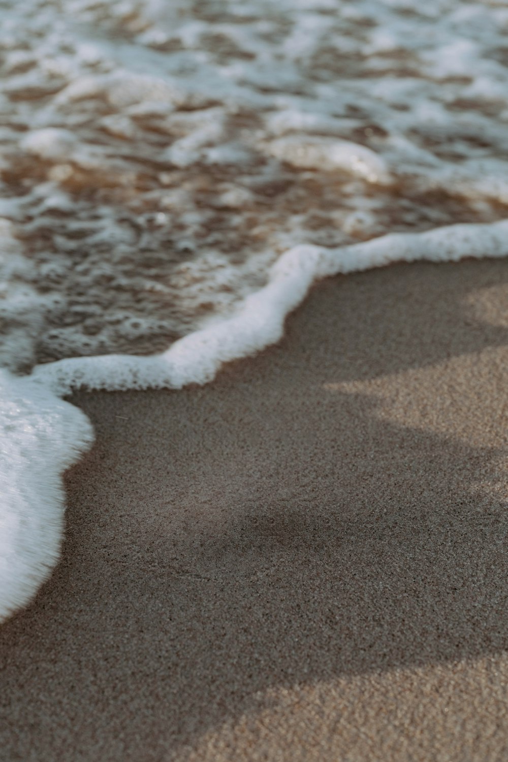 a close up of a wave coming in from the ocean