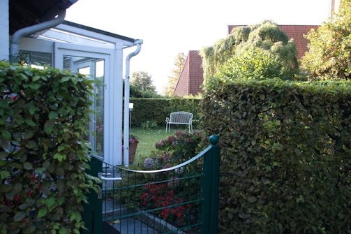 An elegant aluminum garden furniture set in a beautiful garden.