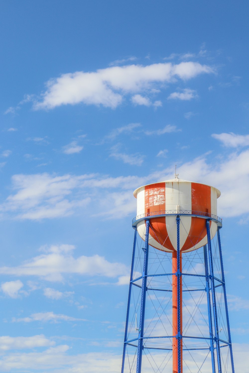 a tall water tower with a sky background