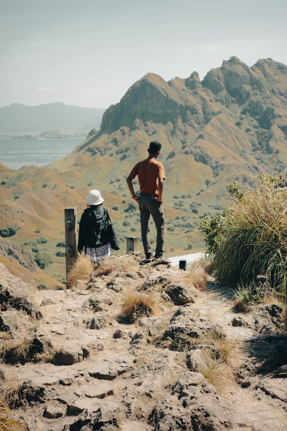 a couple of people standing on top of a mountain