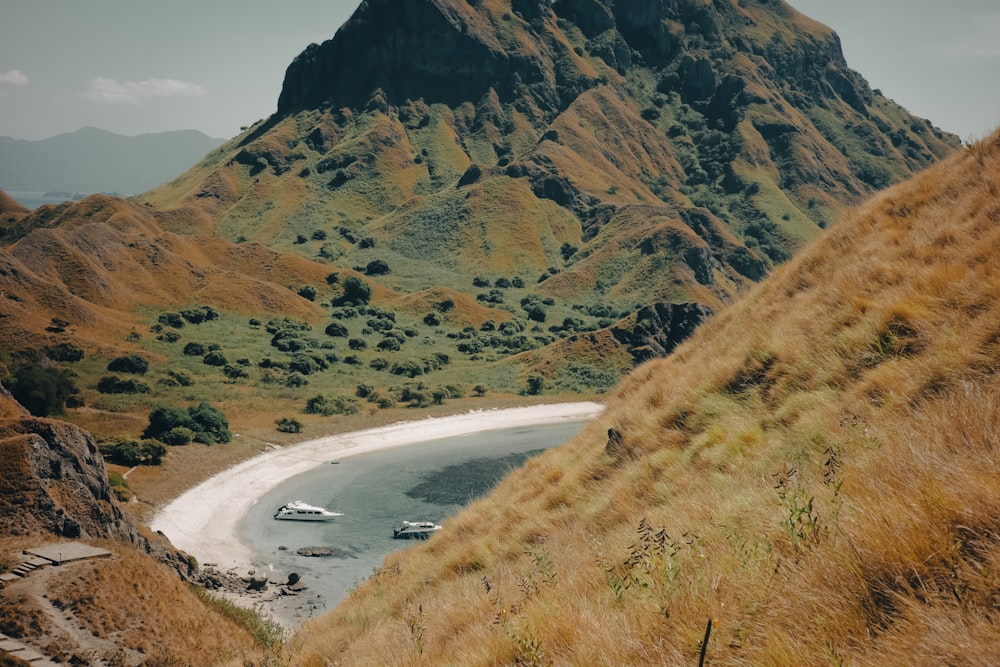 a boat is on the water near a mountain