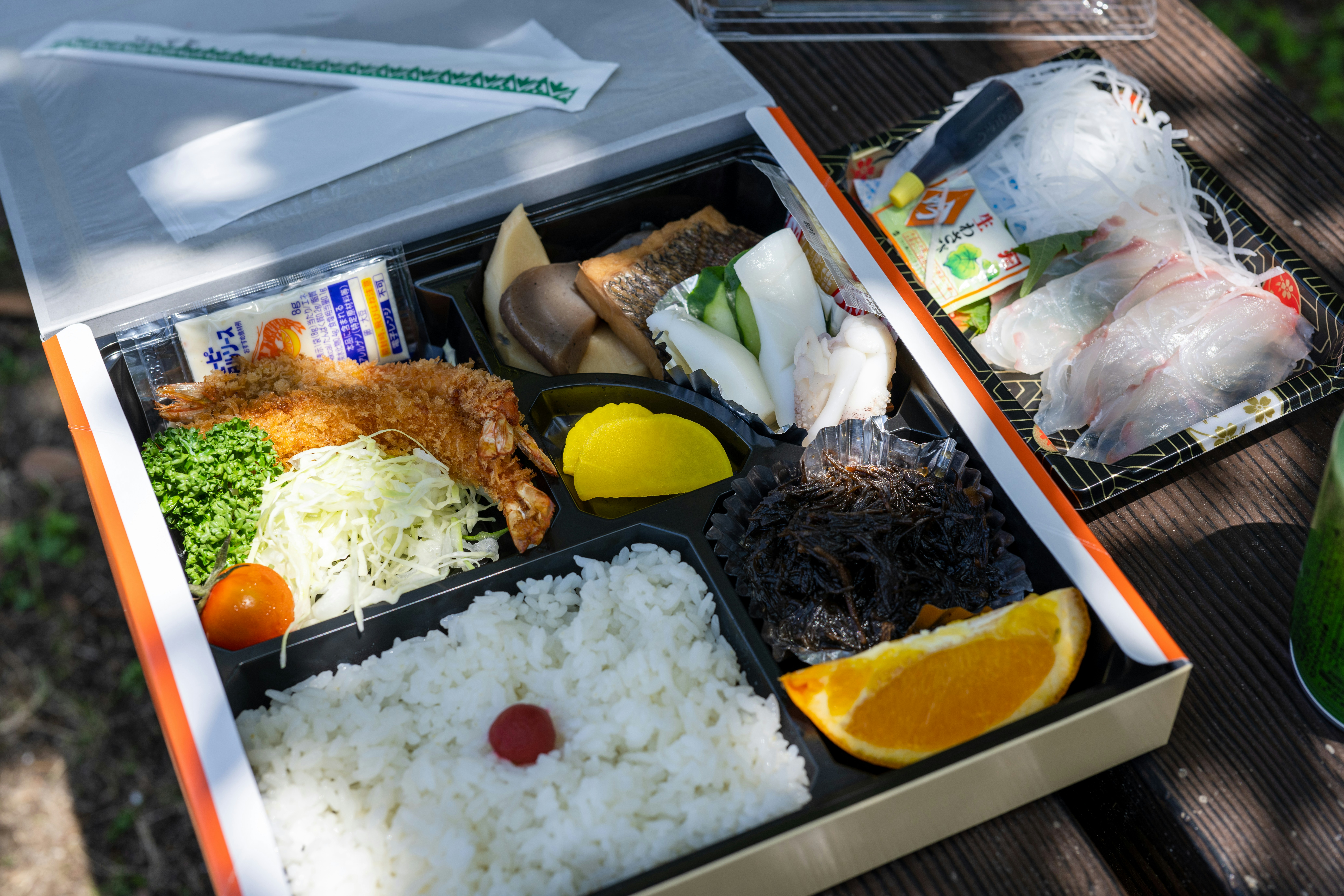 Lunch box with rice, meat, and vegetables