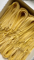 a box filled with lots of yellow noodles