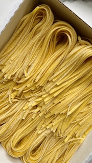 a box filled with lots of yellow noodles