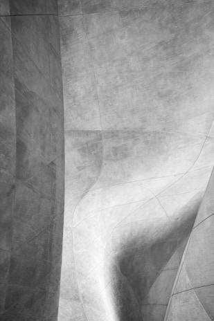 Abstract soft grey architectural forms creating a sense of depth and progress on a pure black canvas.