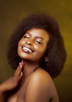A close-up of a woman smiling brightly during a private Fire Body session with Elena.