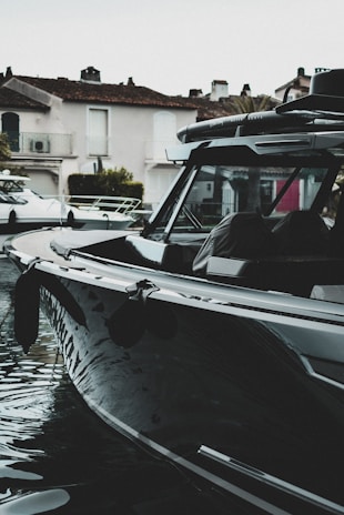 A boat docked with its hull and deck meticulously cleaned and polished.