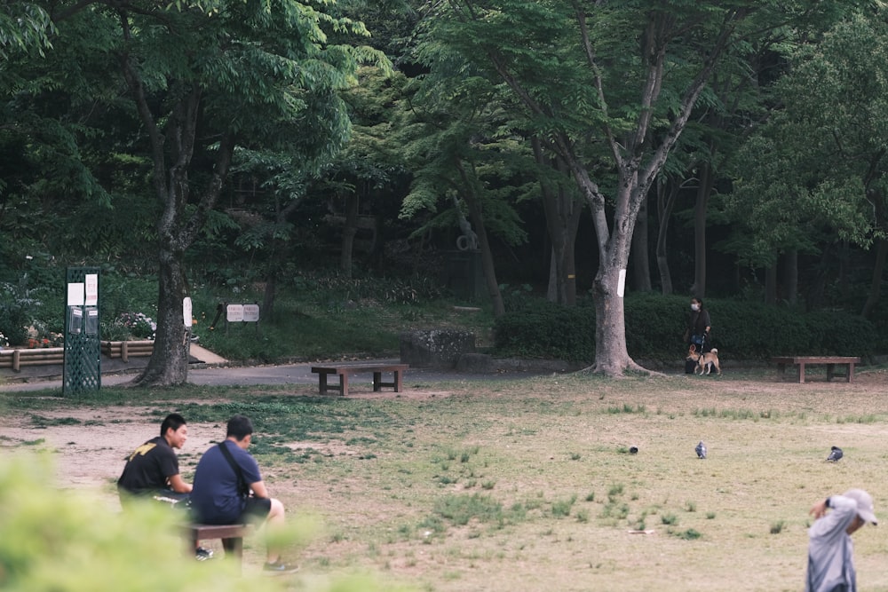 a group of people sitting around a park
