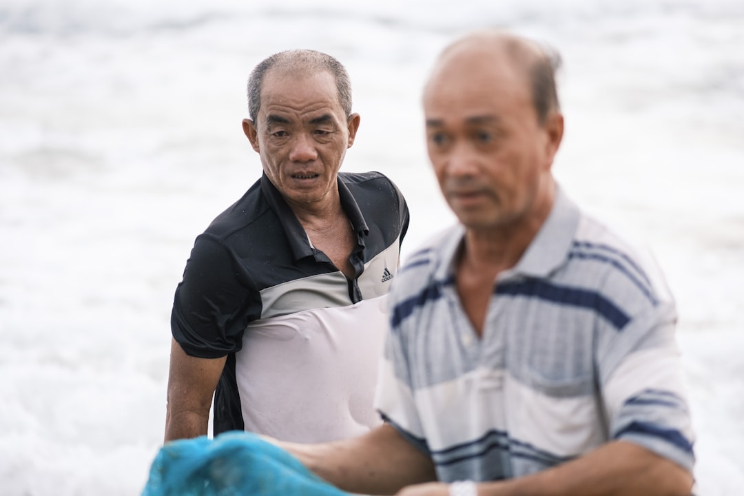 a couple of men standing next to each other,