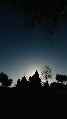 A scenic backdrop featuring a temple during sunset, enhancing the atmosphere.