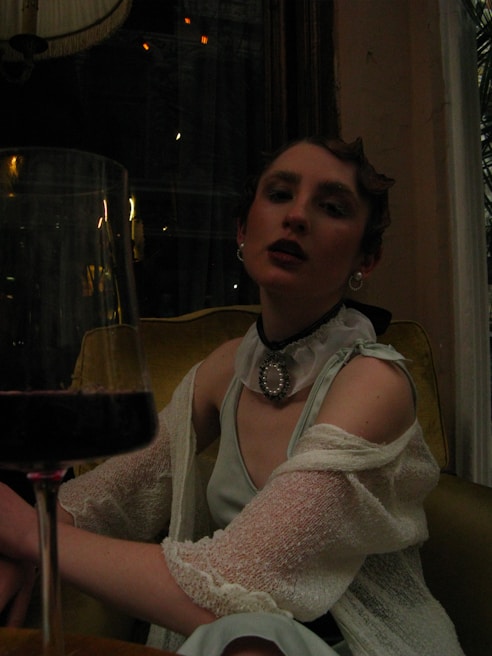 Elegant investor enjoying a glass of wine in a luxurious living room with minimalist design