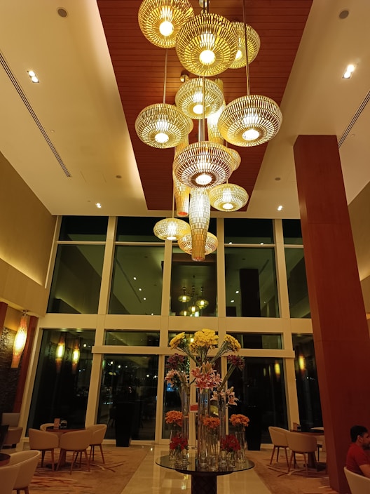 Elegant chandelier casting warm light in a five-star hotel lobby