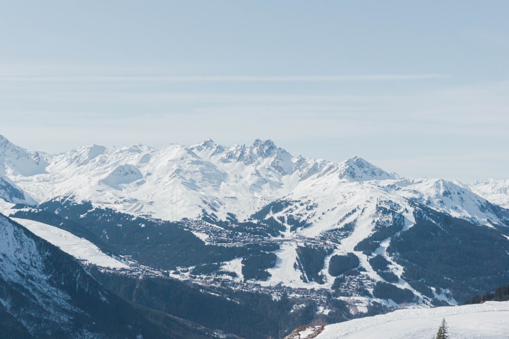 a person standing on top of a snow covered mountain