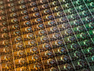 Macro shot of a microchip embedded on a smooth, reflective surface.