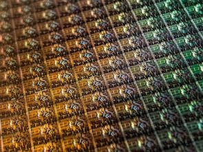 Array of tiny semiconductor components neatly arranged on a reflective surface.